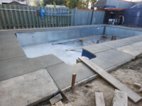 K.Wind Pools 8 laying sidewalk around Lorrie and Deans pool